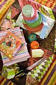 Colourful hotchpotch of haberdashers' goods spread on patchwork blanket