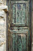 Weathered wooden door with patches of old paint