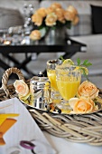 Gin and orange on a tray decorated with flowers