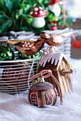 Ornate Christmas bauble and basket of Christmas decorations on rug