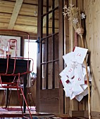 Hand-sewn parcels hanging from willow besom broom as Advent calendar