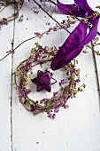 Wreath of beautyberry with purple, glass, star-shaped bauble
