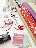 Wrapping paper, ribbons and tape dispenser