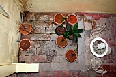 Bird's eye view of terrace chairs and planters in rustic courtyard