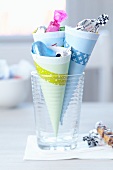 Paper cones held together with masking tape as holders for sweets