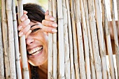 Close up of woman smiling behind fence