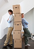 Couple with stack of cardboard boxes