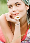 Young woman with flower in mouth, portrait