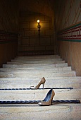 Pair of high-heeled shoes on staircase