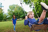 Boy on swing in garden