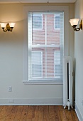 Empty room in apartment with hardwood floor and heater