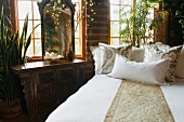White and gold bed runner and pillows on bed