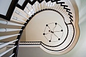 Looking up at contemporary winding staircase and contemporary chandelier