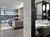 Blick ins offene Bad auf Waschtisch und durch breiten Durchgang in modernen Wohnraum