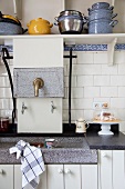 Rustic kitchen counter with stone sink and white base units