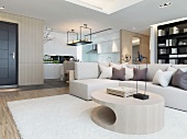 Oval coffee table in front of corner sofa in open-plan interior