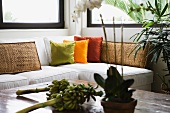 White corner sofa with brightly colored throw pillows