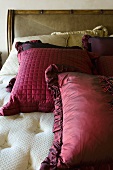 Red throw pillows on a large bed