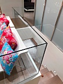 Colorful floral pillows on chairs at top of staircase