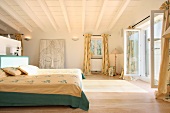 Master bedroom with French doors open to outdoor balcony