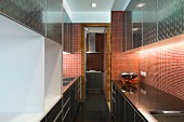 Modern kitchen with cabinets and mosaic tile wall