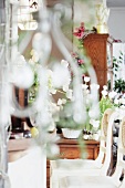 View into room with white chairs and decorated with bouquets