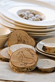 Place cards made of tree discs and decorated for Easter