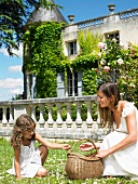 Bride picking up flowers with girl