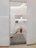 View through a white lobby into a bedroom