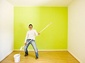 Man rocking while painting a room