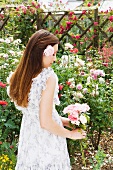 Woman holding roses, side view