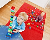 boy and baby with toy building blocks