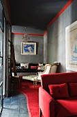 Red velvet and white cotton fabrics in living room of Marrakesh medina home with artwork by Paul Jacquette