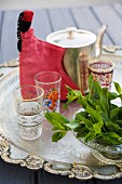 Mint leaves and tea glasses with teapot, Marrakesh