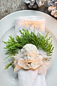 White crockery decorated with cypress and Christmas angel