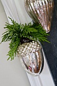 Christmas decoration of silver acorns with cypress sprigs