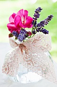 Glass with lavender and geraniums, tied with decorative ribbon