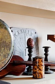 Antique violin, wooden candle sticks and sun dial on a birchwood shelf