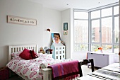 Light and bright teenage bedroom with a glass bay window