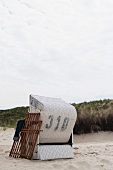 Roofed wicker beach chair at the dune beach on Spiekeroog (Germany)
