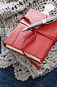 Small, leather-bound book on crocheted blanket
