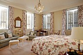 Romantic double room in elegant country-house style with Provençal rose patterns and antique furnishings in traditional hotel