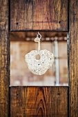 Decorative, hanging natural stone in a wooden window opening