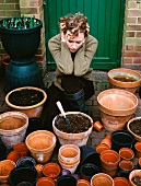 Gardener looking at plant pots