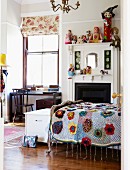 Vintage child's bedroom with crocheted blanket on bed and desk below window