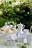 White porcelain crockery and sweet petits fours on a table outdoors