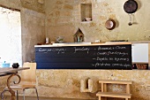 Raised kitchen island within ancient sandstone walls of Chateau Maignaut