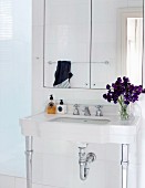 China washstand with decorative metal legs and integrated mirrored cabinet