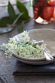 Cow parsley and silver fork in a dish