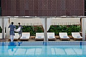 Hotel staff working next to luxurious swimming pool in Raas Haveli Hotel, Jodhpur, India